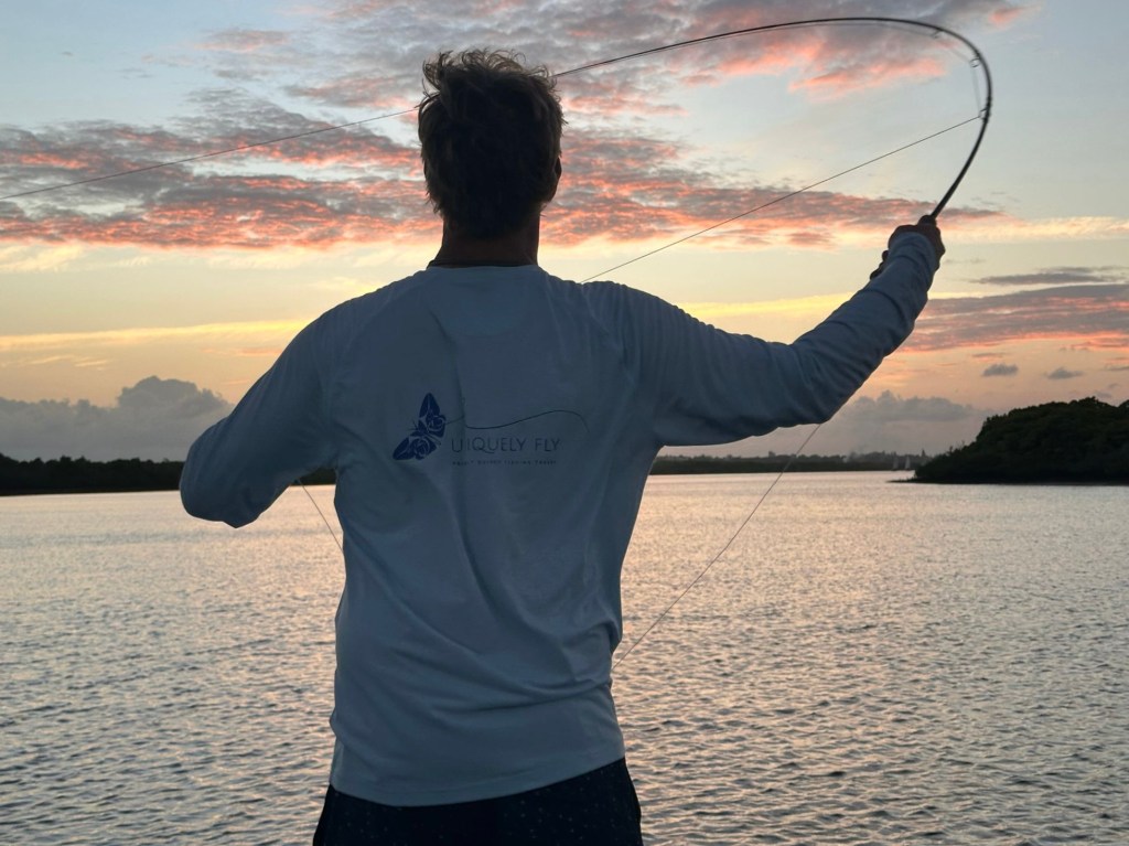 Angler fly fishing at sunrise on a guided fishing trip